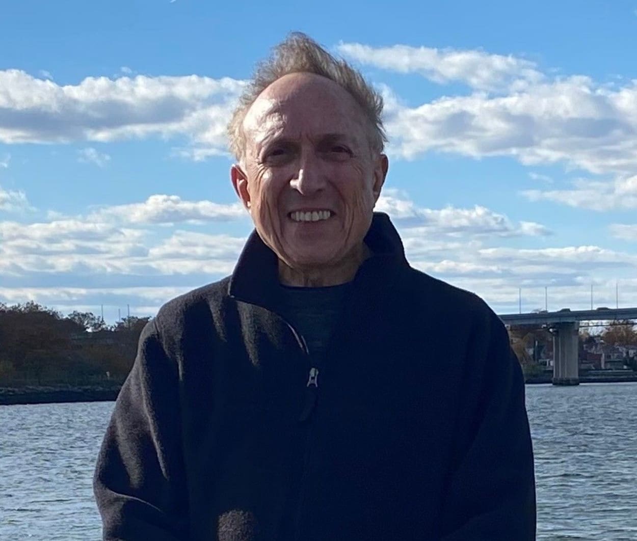 A man standing in front of the water.